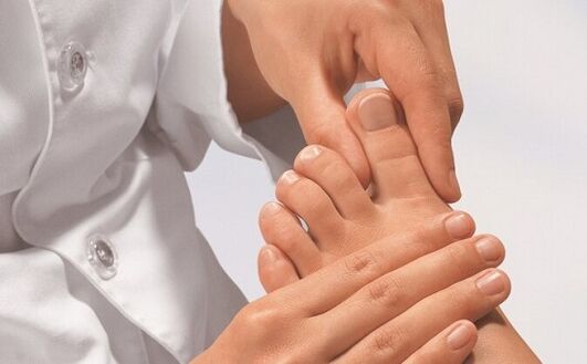 The specialist examines the feet for fungal infection